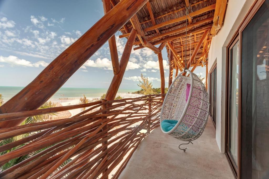 a room with a hammock and a view of the beach at Mystique Holbox by Royalton, A Tribute Portfolio Resort in Holbox Island