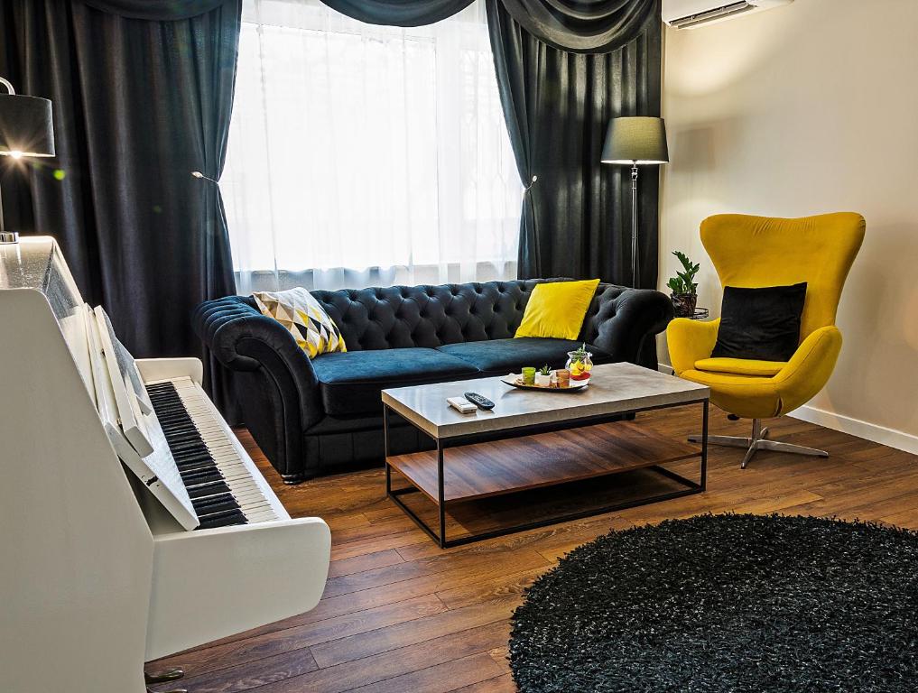 a living room with a couch and a piano at Guest House Amaya in Plovdiv