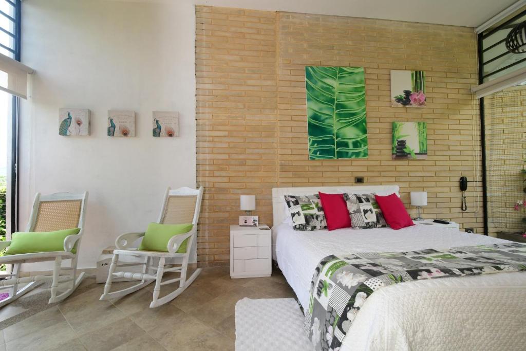 Postel nebo postele na pokoji v ubytování Hotel Casa Ambrosia