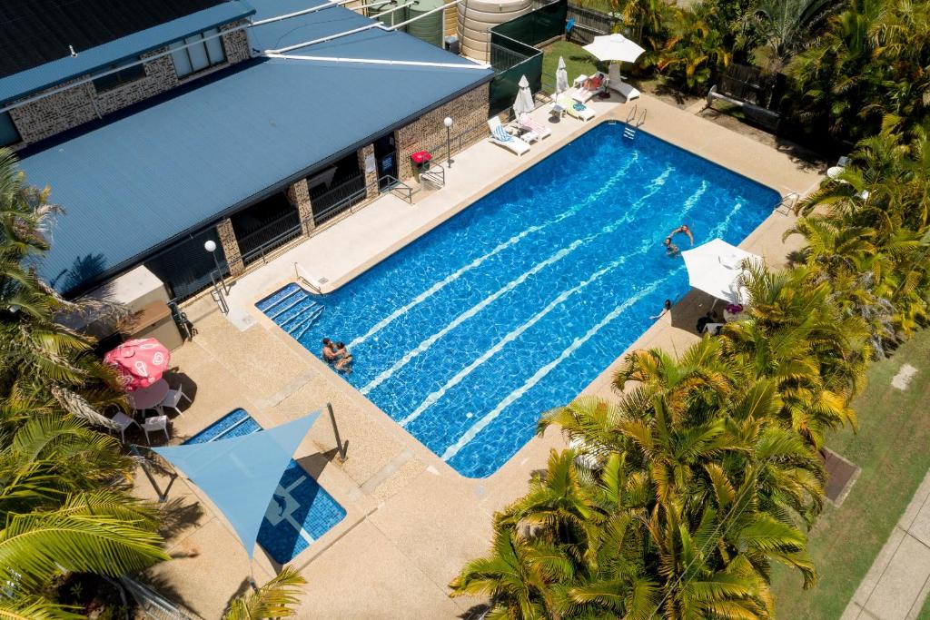 an overhead view of a swimming pool with palm trees at Ingenia Holidays Noosa North in Tewantin