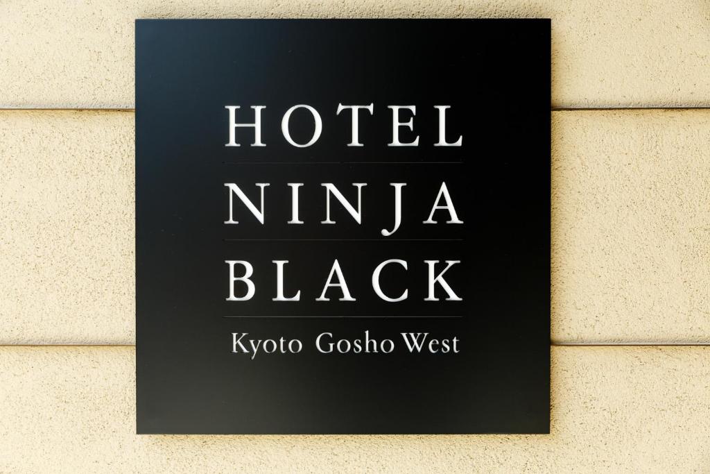 a sign for a hotel nina black on a wall at Hotel Ninja Black in Kyoto