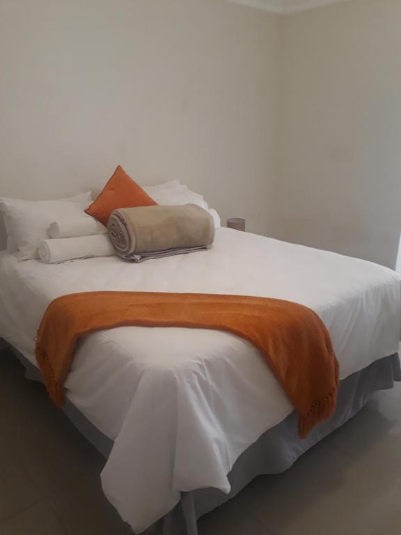 a large bed with white sheets and pillows on it at Elilo Bed and breakfast in Walvis Bay