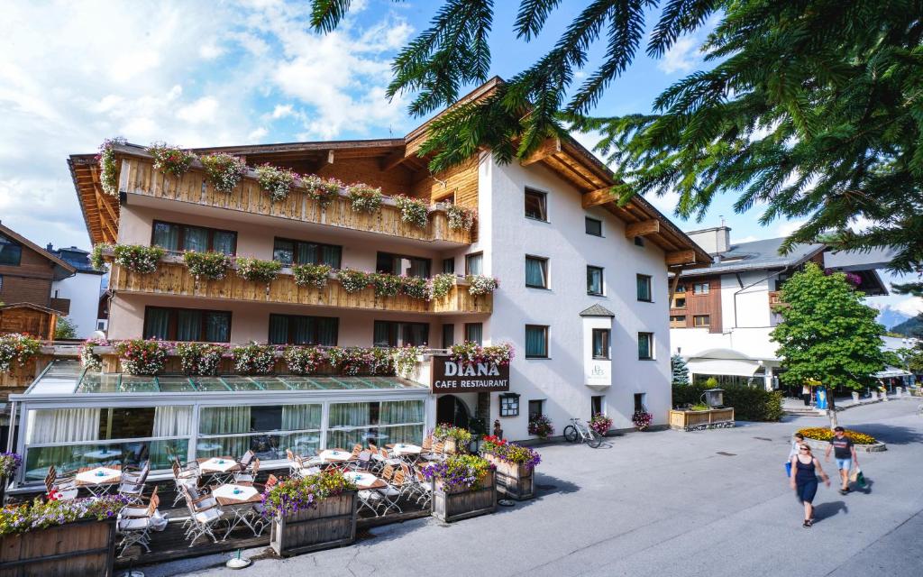 a hotel with tables and chairs in front of it at Hotel Diana in Seefeld in Tirol
