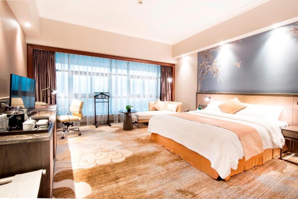 Postel nebo postele na pokoji v ubytování Jin Jiang Pine City Hotel
