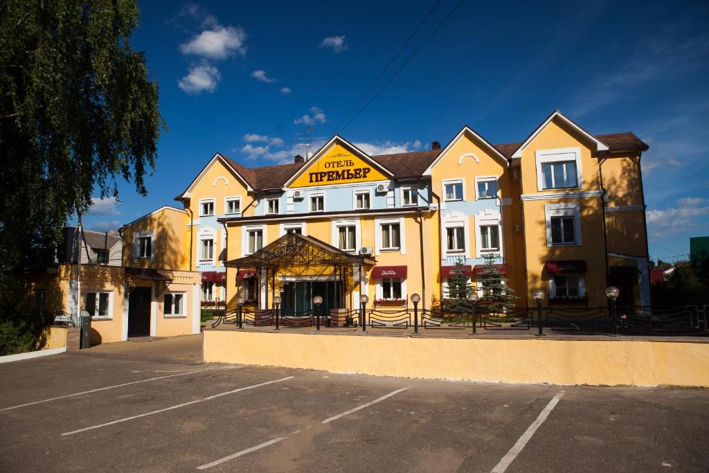 a large building in front of a parking lot at Premier Hotel in Kostroma