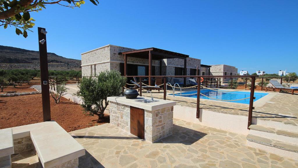 a villa with a swimming pool and a house at Villa Sirena in Xerokampos