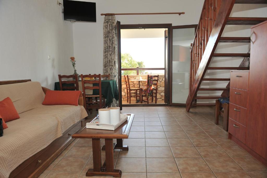 a living room with a couch and a table at Villa Maraki in Agia Paraskevi