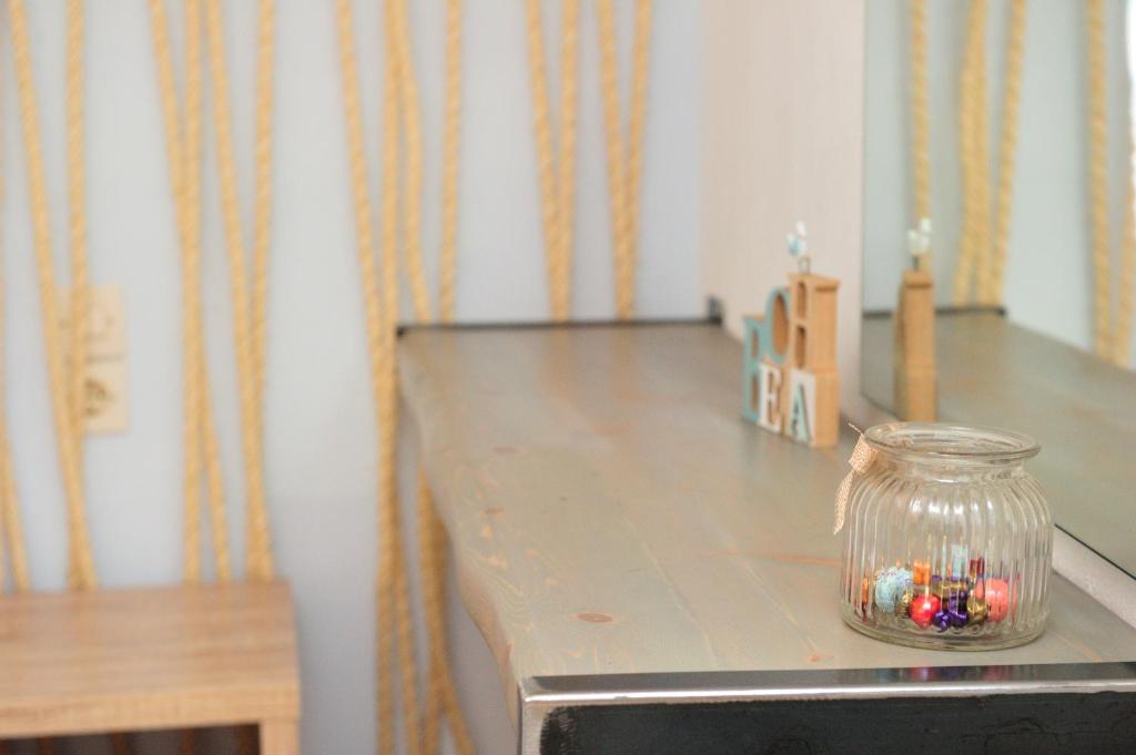 a table with a glass jar with candles on it at Villa Maraki in Agia Paraskevi