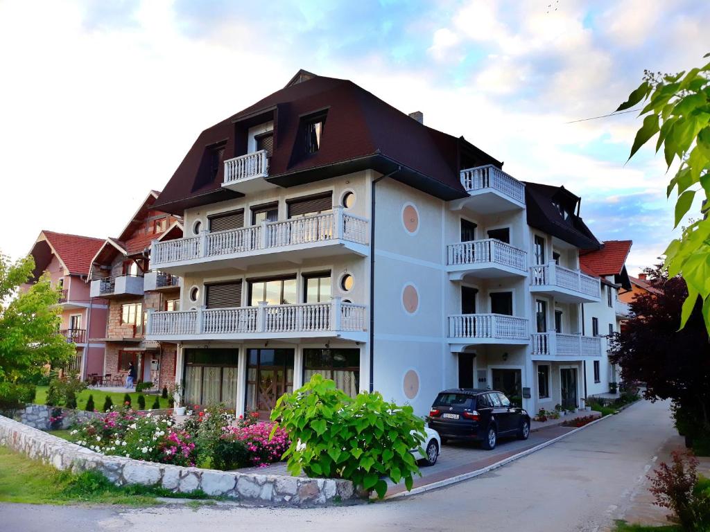 a building with a car parked in front of it at Vila Simic in Soko Banja