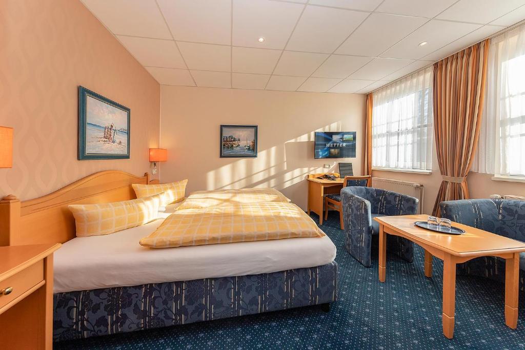 Postel nebo postele na pokoji v ubytování Dünenhotel am Meer
