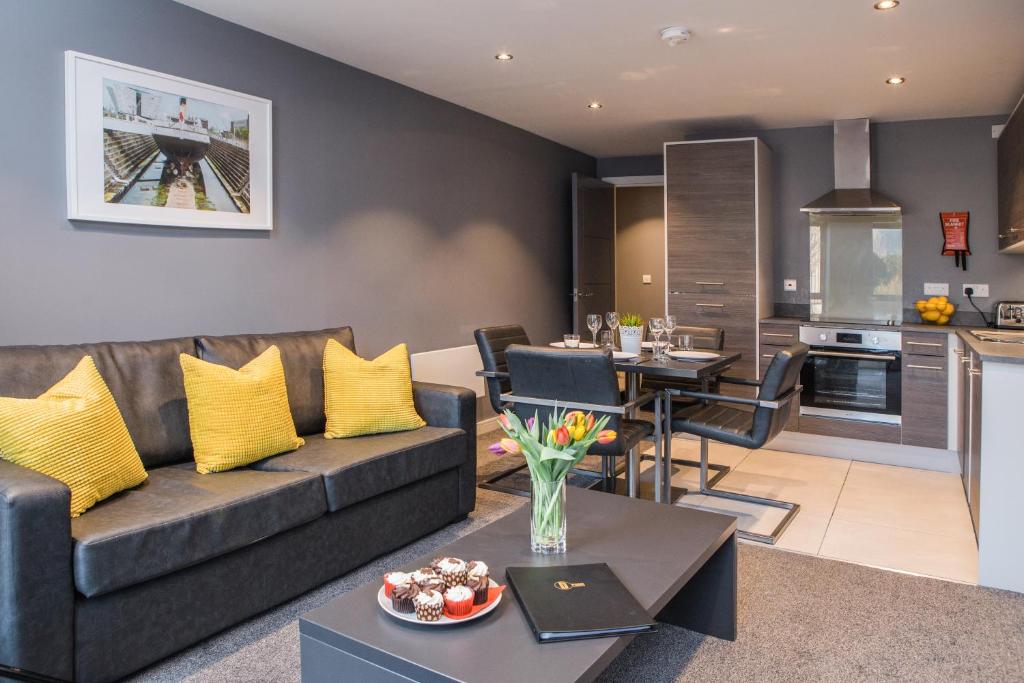 a living room with a couch and a table at Dream Apartments St Thomas Hall in Belfast