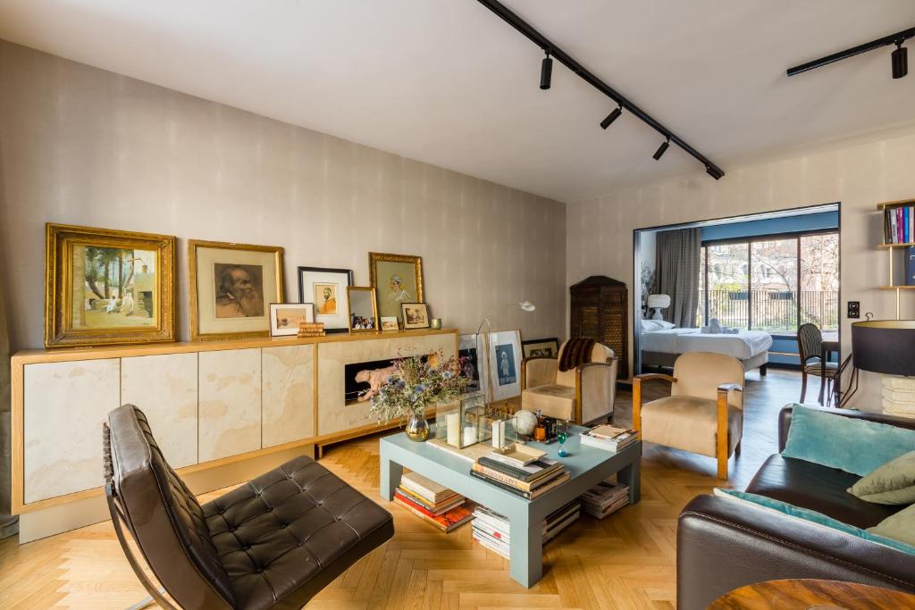 a living room with a couch and a table at Veeve - Bois de Boulogne Retreat in Paris