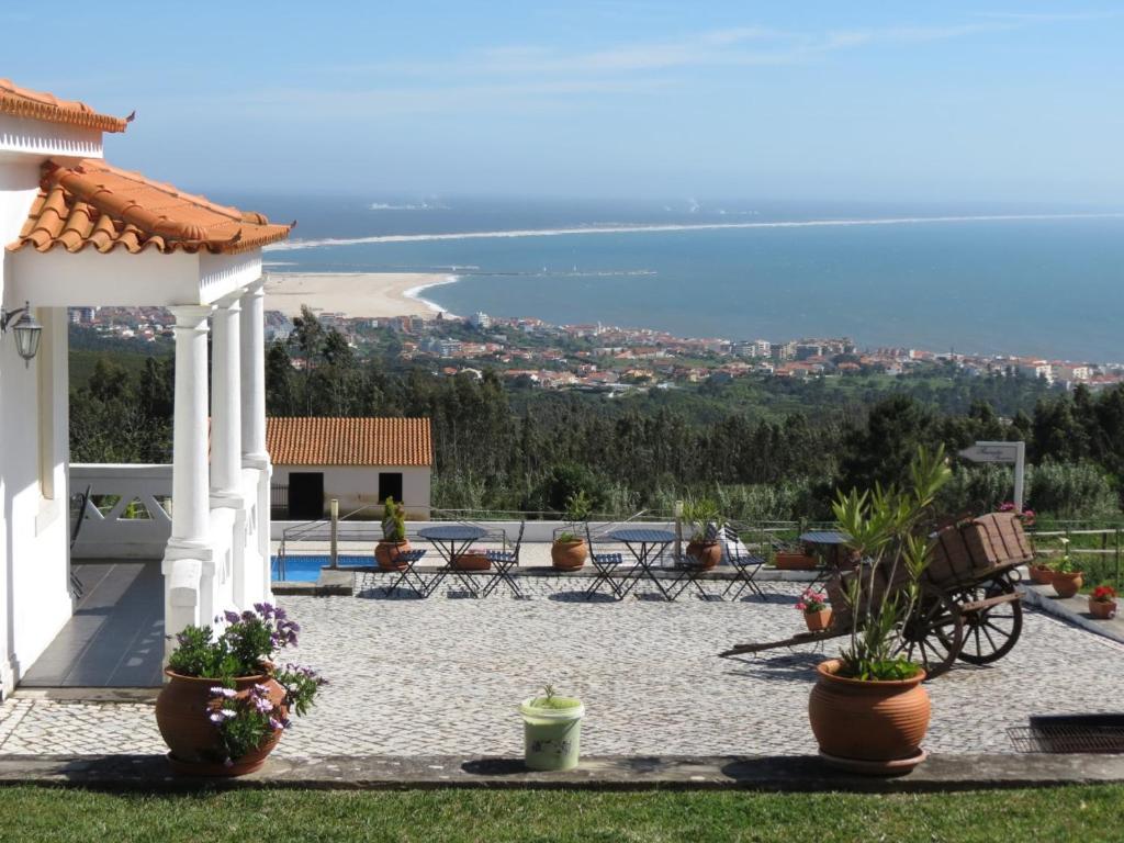 a patio with a gazebo and a view of the ocean at Casa Pinha in Figueira da Foz