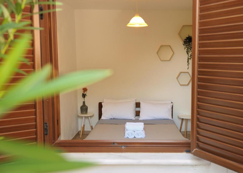 a bedroom with a bed with two white pillows at Villa Maraki in Agia Paraskevi