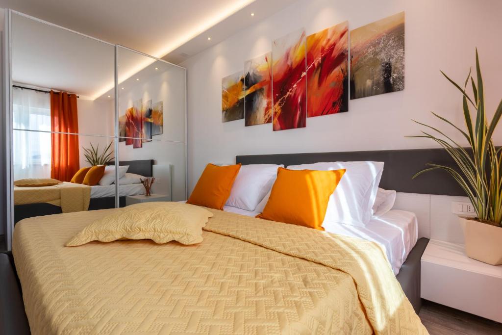 a bedroom with a bed and some paintings on the wall at Villa Valis in Baška