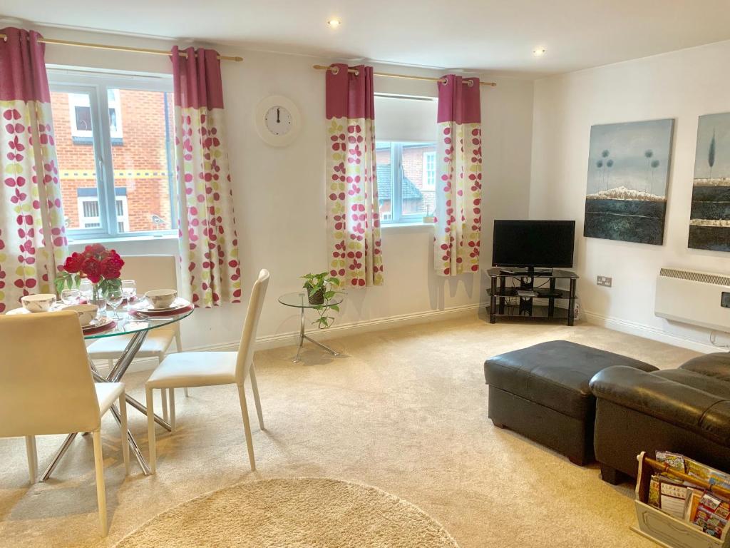 a living room with a couch and a table at Lahnstein Court in Kettering