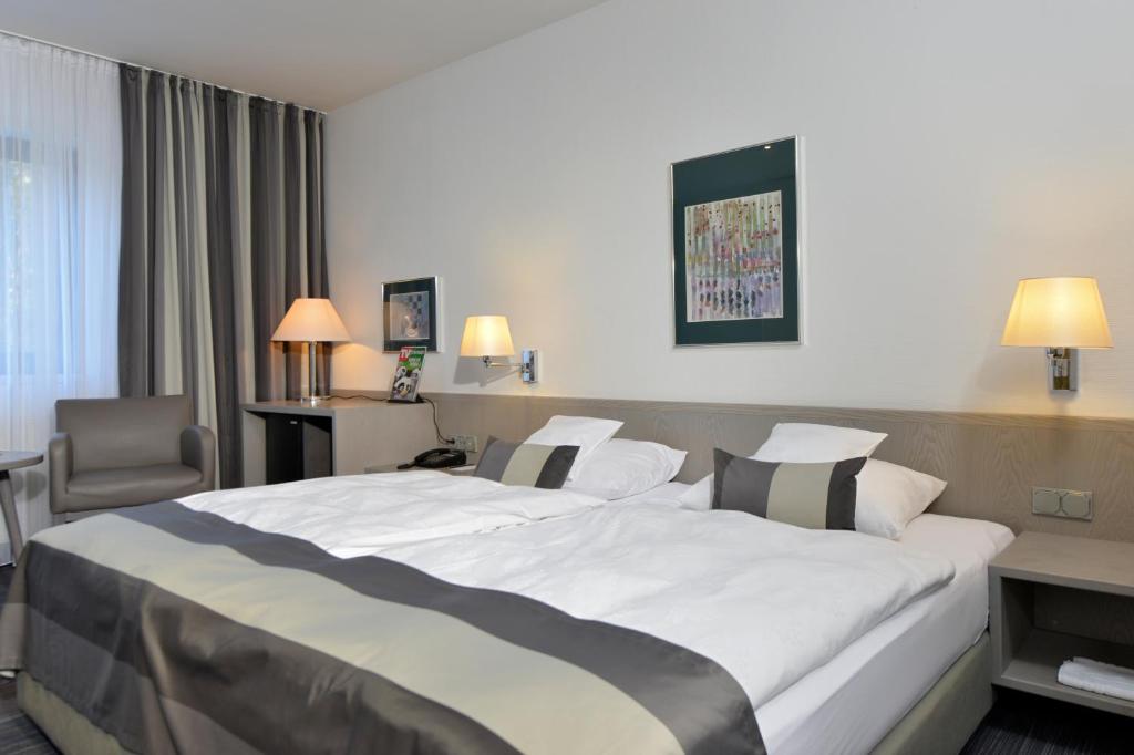 a hotel room with a large bed in a room at Hotel Spiegel in Cologne