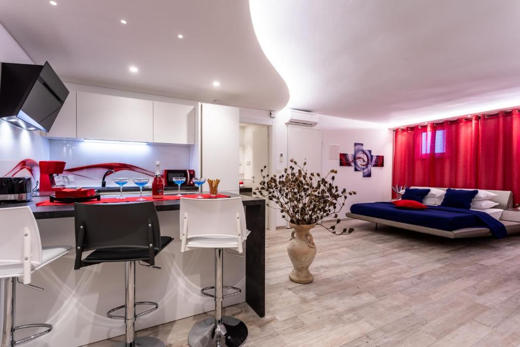 a kitchen and living room with red curtains and a couch at Villa Valis in Baška
