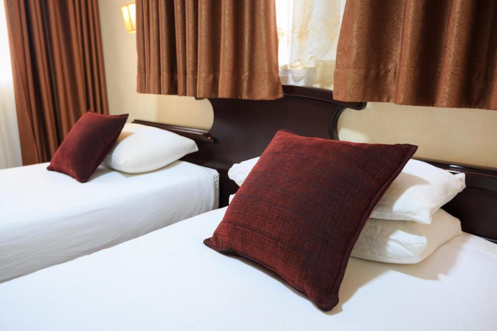 Postel nebo postele na pokoji v ubytování Hashimi Hotel