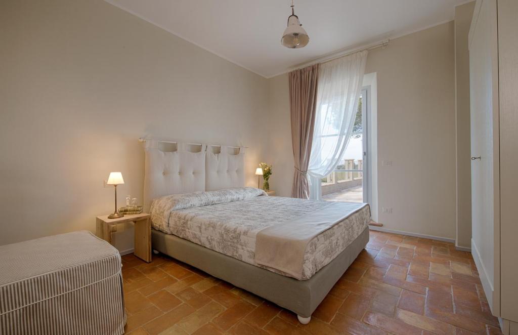 Postel nebo postele na pokoji v ubytování Agriturismo Poderedodici