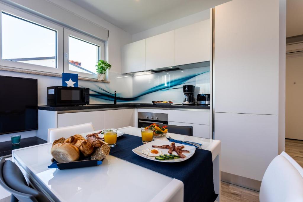 a kitchen with a table with a plate of food on it at Villa Valis in Baška