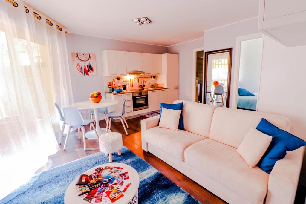 a living room with a white couch and a table at The Princess Monac'home Parking in Monte Carlo