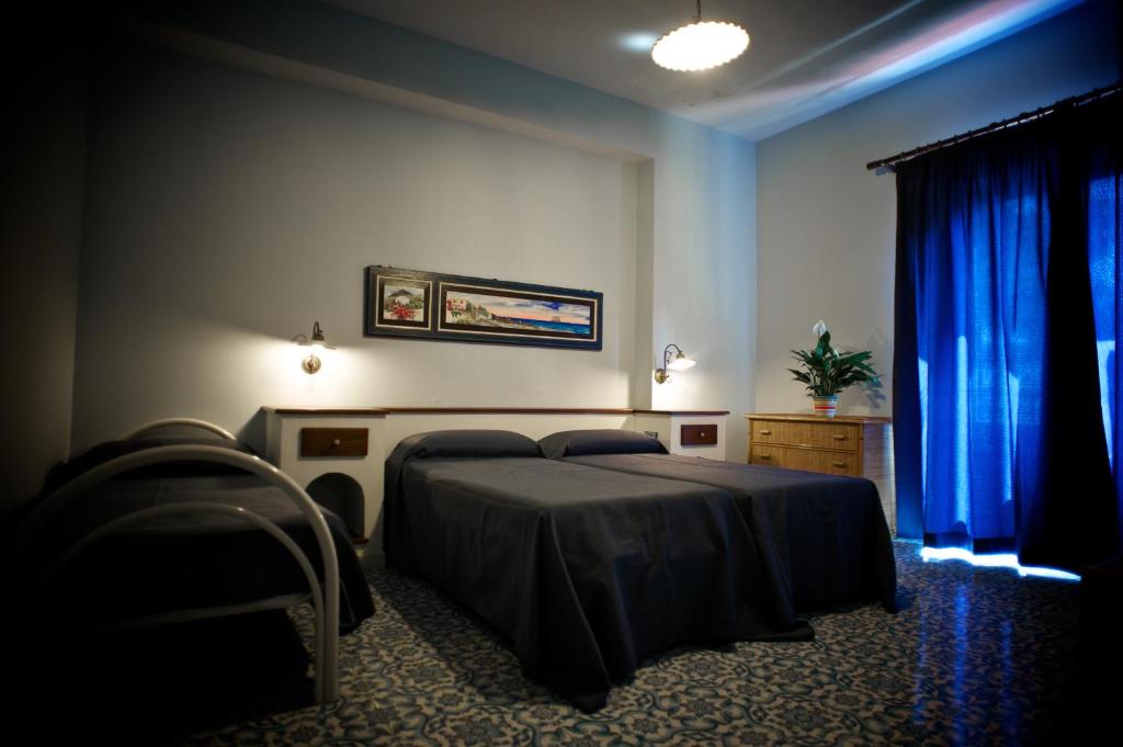 Postel nebo postele na pokoji v ubytování Pietra Pomice Hotel