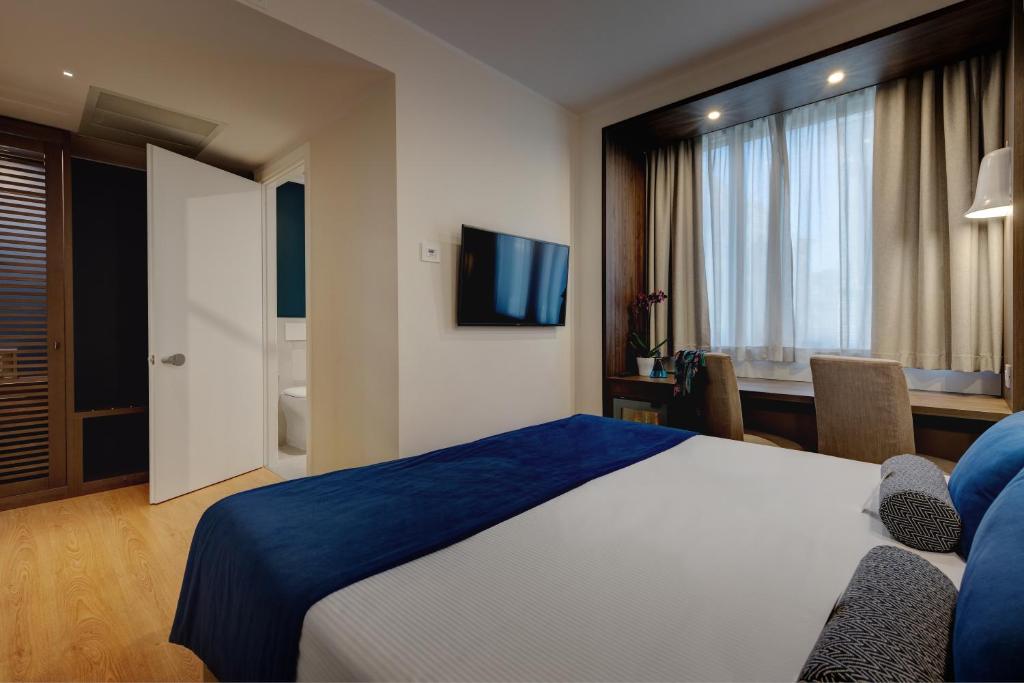 TV a/nebo společenská místnost v ubytování Fly Decó Hotel