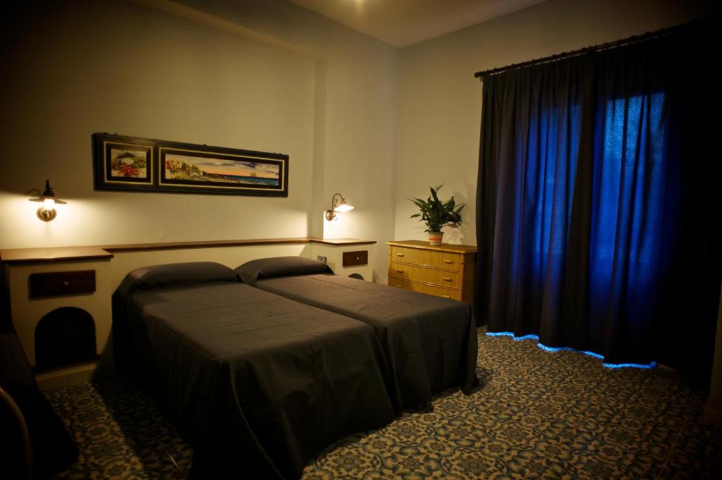Postel nebo postele na pokoji v ubytování Pietra Pomice Hotel