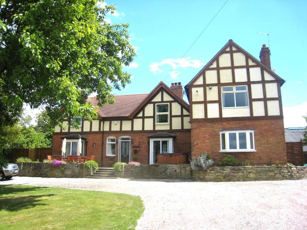 a large house with a brick at Arden Hill Farmhouse - Hot Tub, Snooker Table, Sleeps 16 in Stratford-upon-Avon