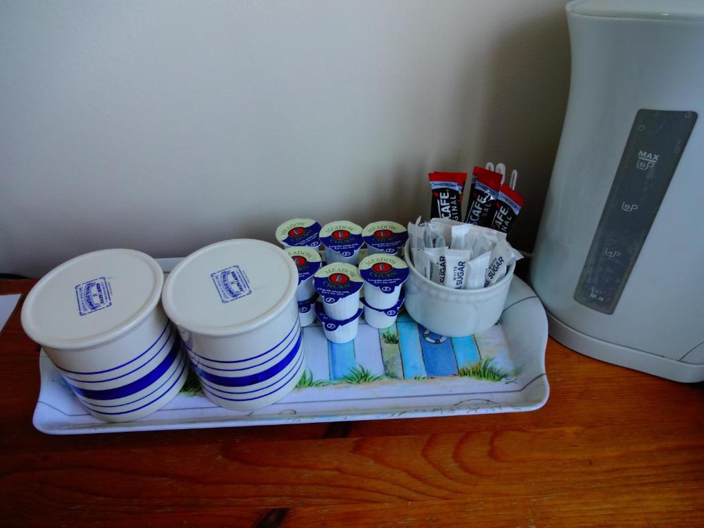 a tray of cups and plates on a table at Travellers Rest Motel in Ingoldmells