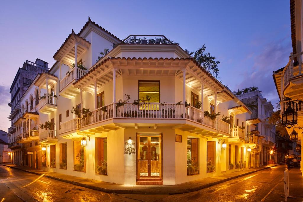 a large white building on a street at night at Hotel Boutique Casona del Colegio in Cartagena de Indias