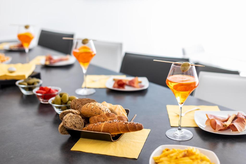 a table with plates of food and a glass of wine at Villa Valis in Baška
