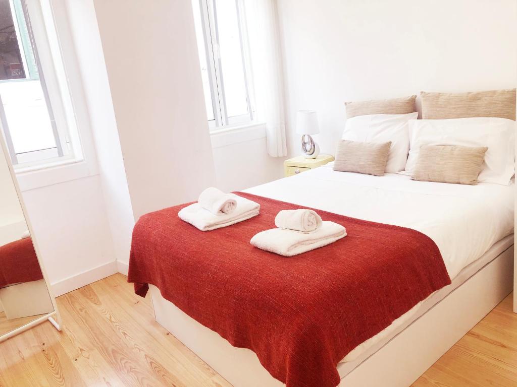 a bedroom with a bed with two towels on it at Lisbon Central Apartment with Terrace in Lisbon