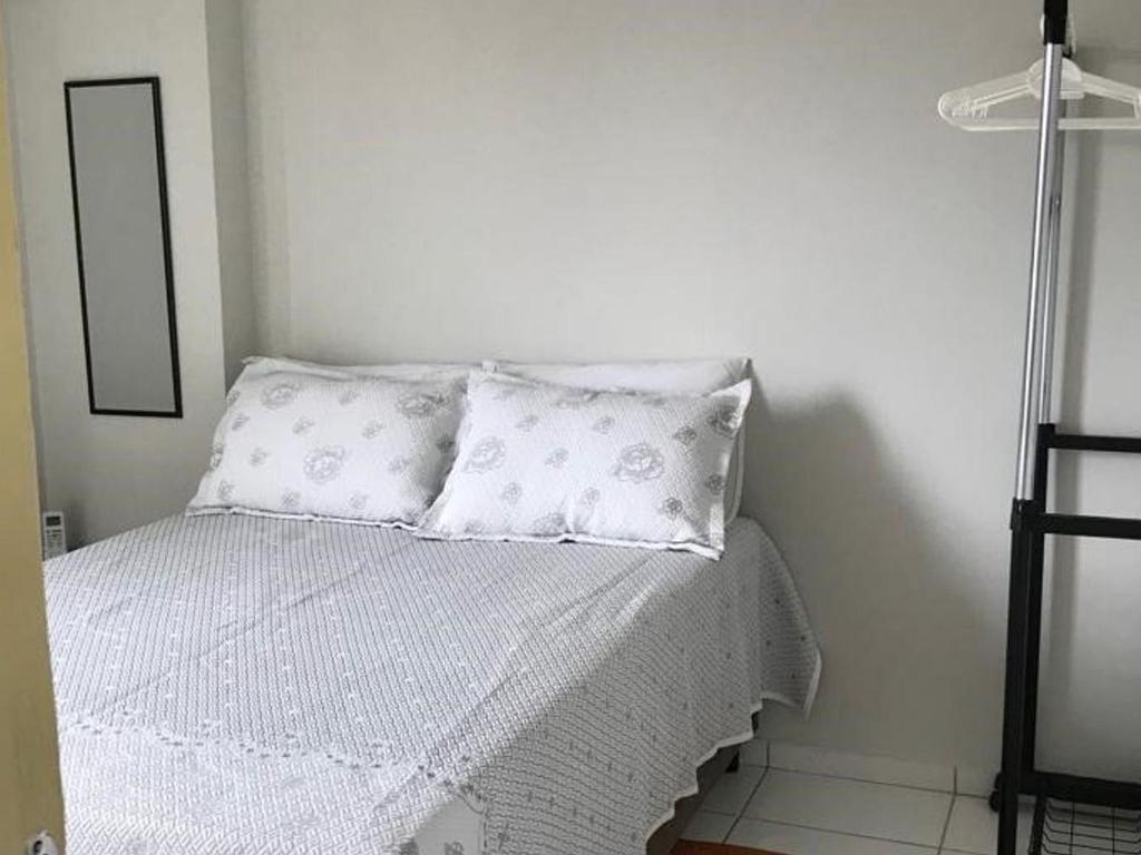 - un lit blanc avec des oreillers blancs dans l'établissement BrunoApartamentos Recife - Boa Vista - Apt 1203 (temporada), à Récife