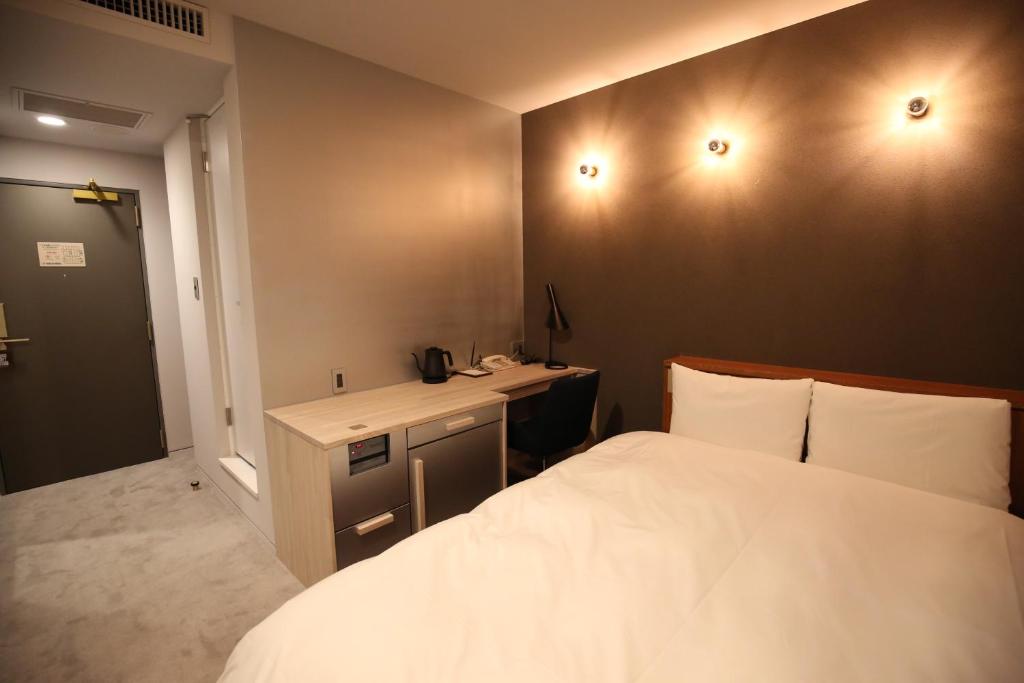 Ένα ή περισσότερα κρεβάτια σε δωμάτιο στο Excel Inn Nagoya Atsuta