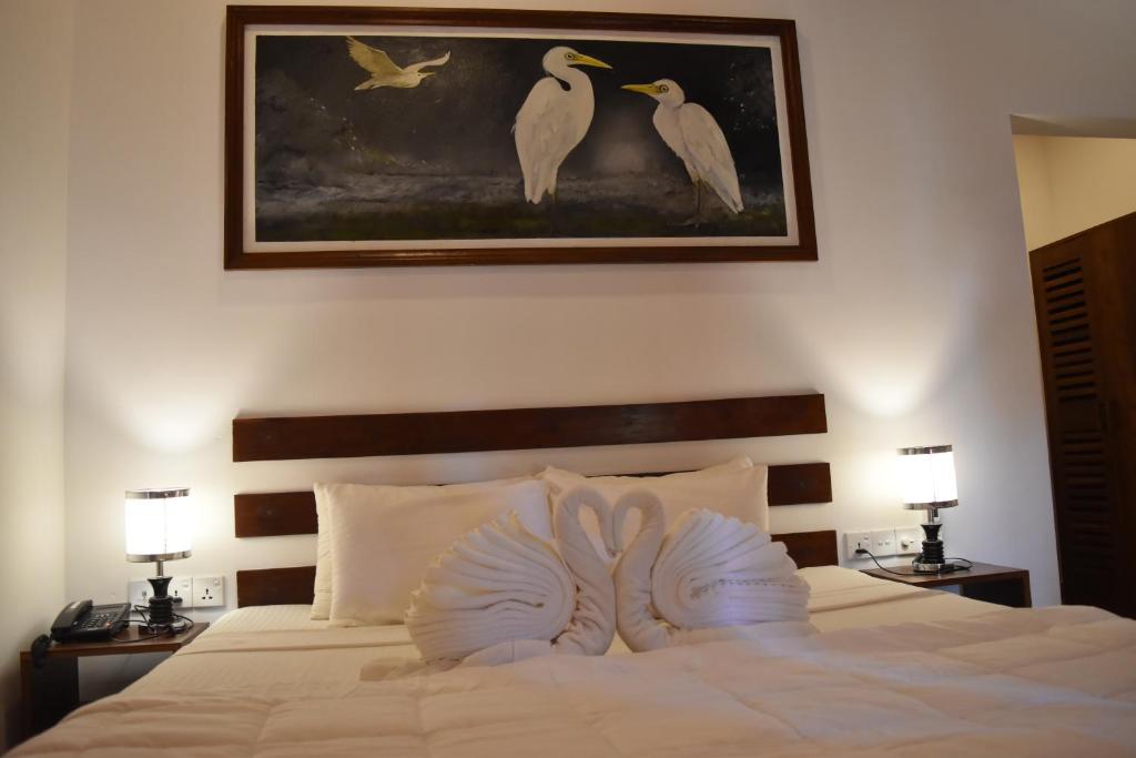 Postel nebo postele na pokoji v ubytování Sigiri Asna Nature Resort