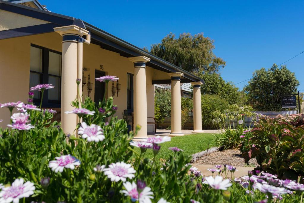 a house with flowers in the front yard at Agnes Cottage Bed & Breakfast in Kingston South East