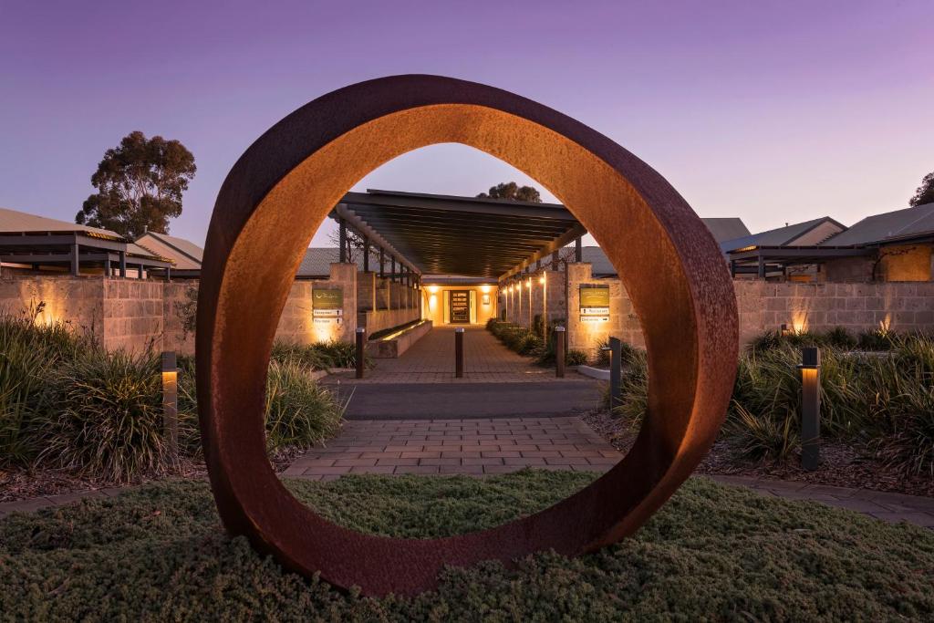 a large circle sculpture in front of a building at The Louise in Marananga