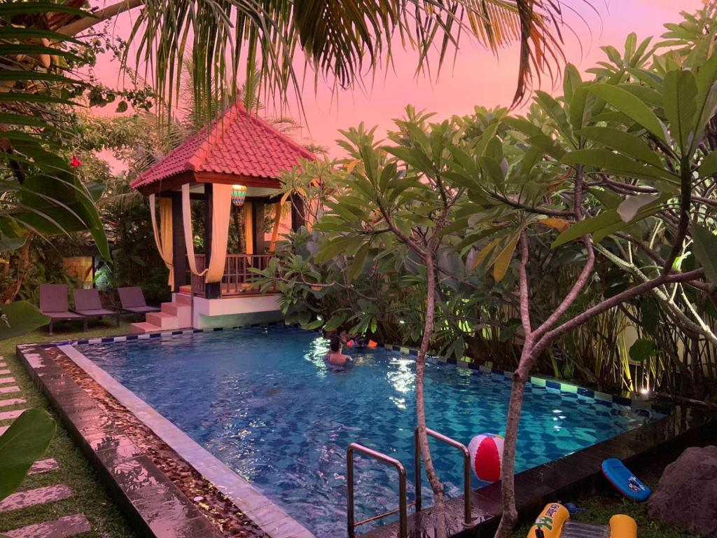 a swimming pool with a gazebo in a resort at Villa Rosseno - Evelyn Private pool and Garden in Yogyakarta