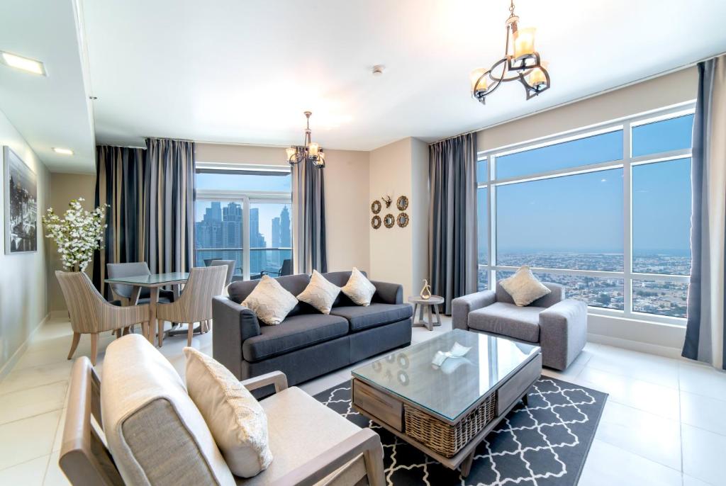 a living room with a couch and a table at Icon Casa Living - Super Loft West Tower in Dubai