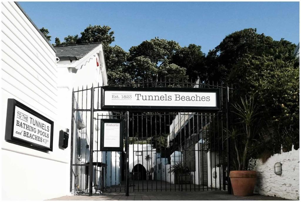 a gate with a sign that reads tunnels beeches at Runnacleave Court in Ilfracombe