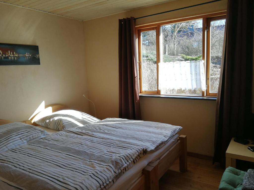 Schlafzimmer mit einem Bett vor einem Fenster in der Unterkunft Ferienwohnung "Eifelstueffje" in Mechernich