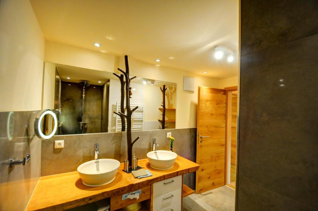 a bathroom with two sinks and a shower at Dienbergerhof 5 Sterne Ferienwohnungen in Untergriesbach