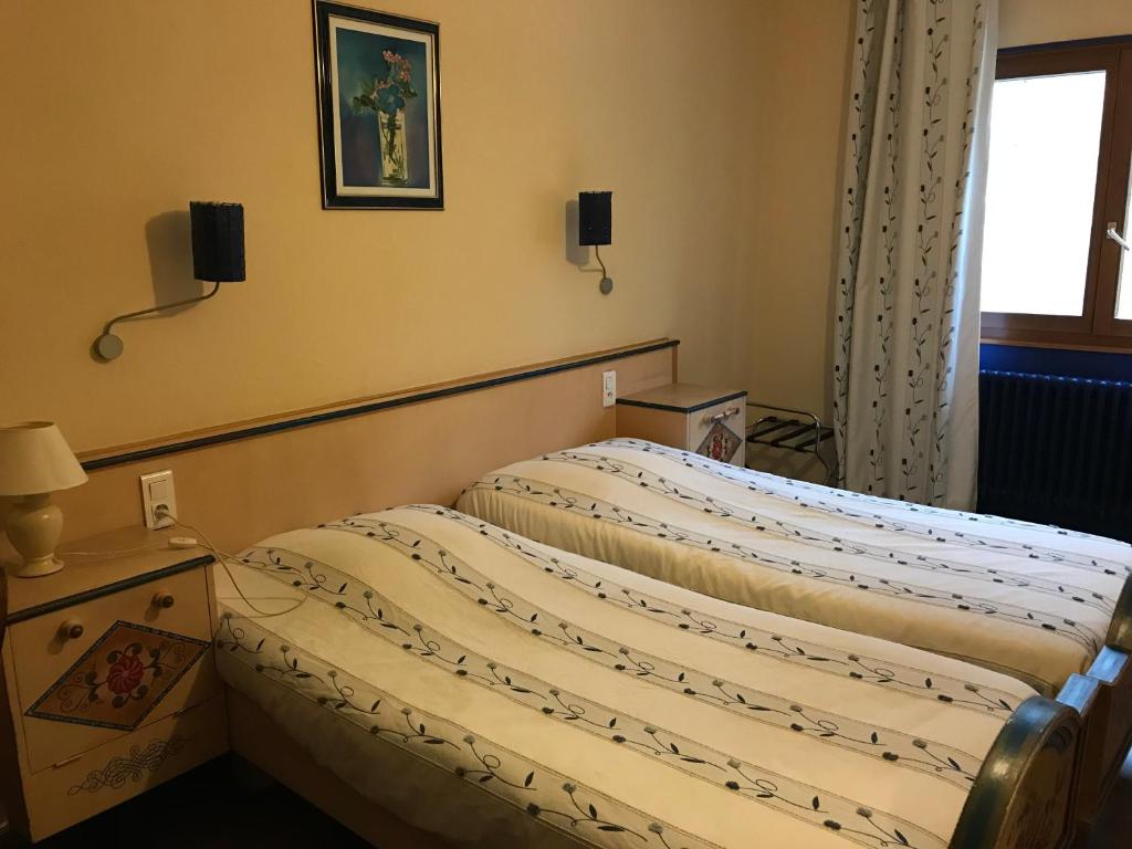 Postel nebo postele na pokoji v ubytování Hotel Restaurant Perle Des Vosges