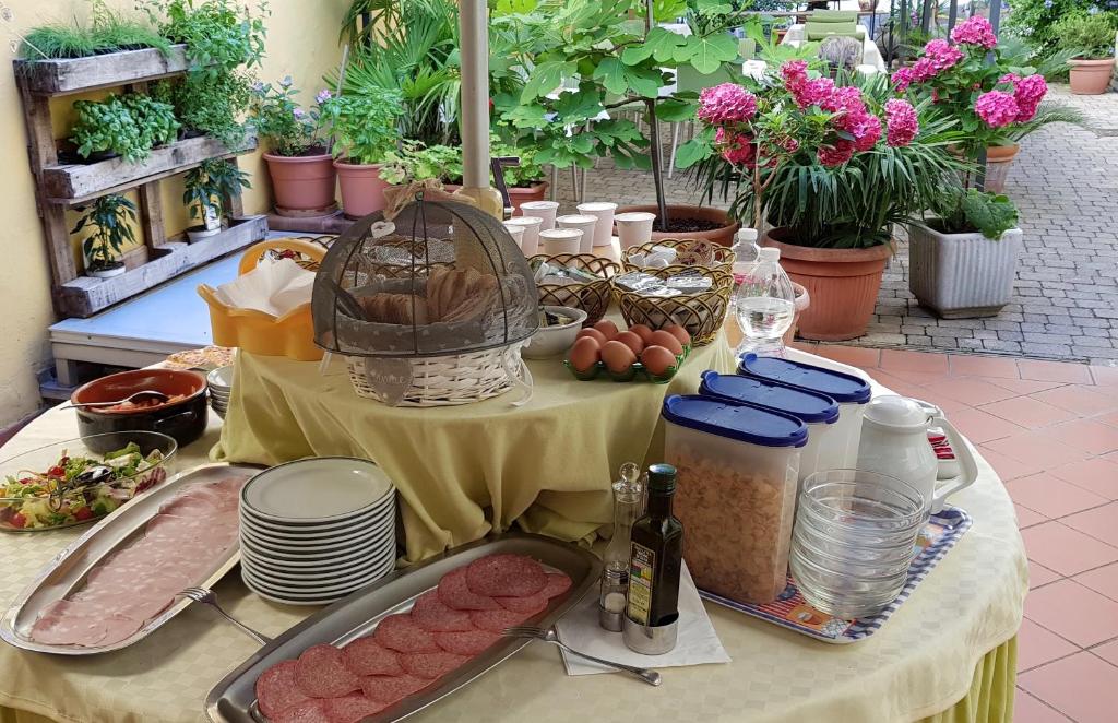 a table with meat and other food on it at Albergo Natucci in Montecatini Terme