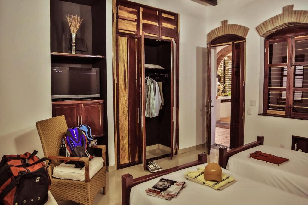 Postel nebo postele na pokoji v ubytování Casa de Isabella, a Kali Hotel
