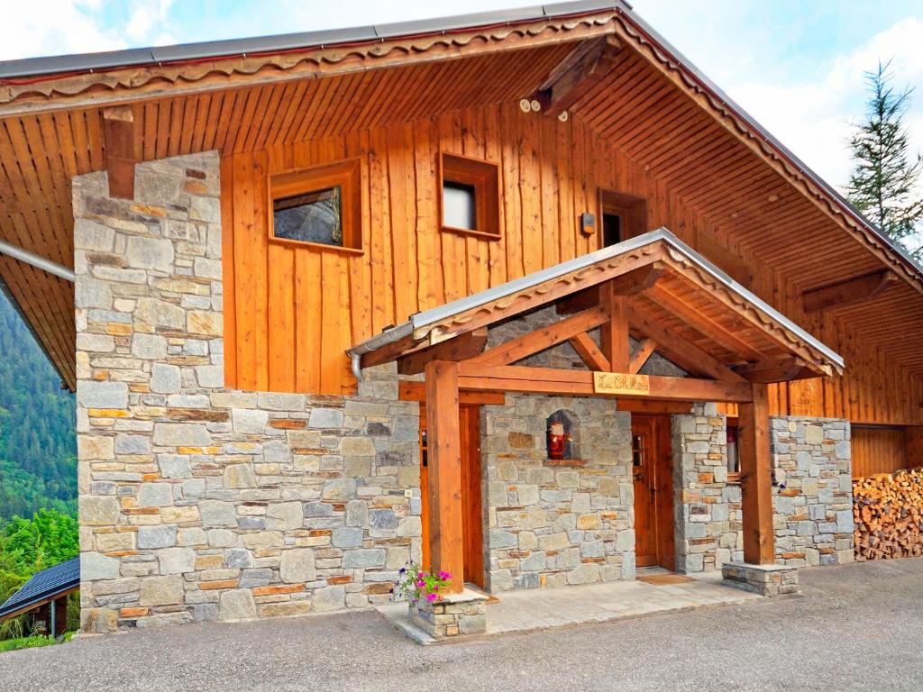 a building with a stone and wood at Luxurious Chalet in Champagny en Vanoise near Ski Area in Champagny-en-Vanoise