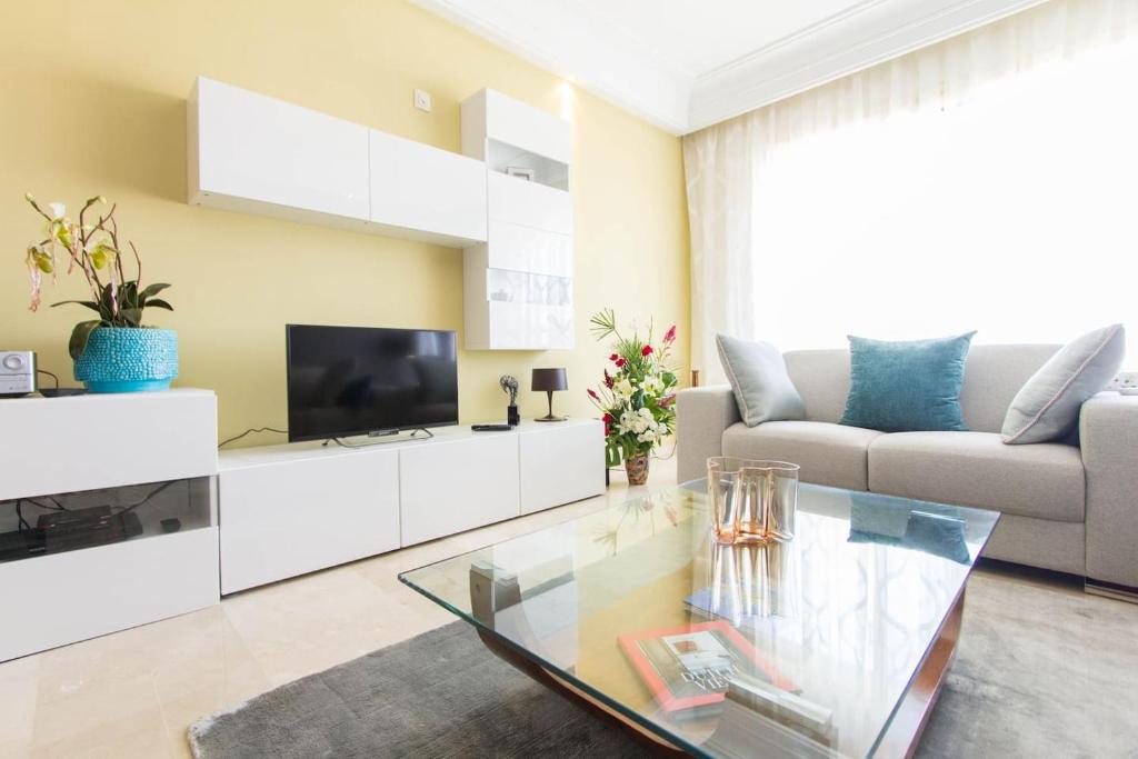 a living room with a couch and a tv at Luxurious apartment, European Quality in Casablanca