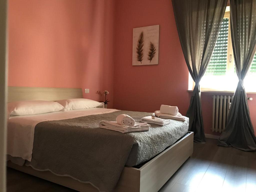 Postel nebo postele na pokoji v ubytování L'Arena Residence